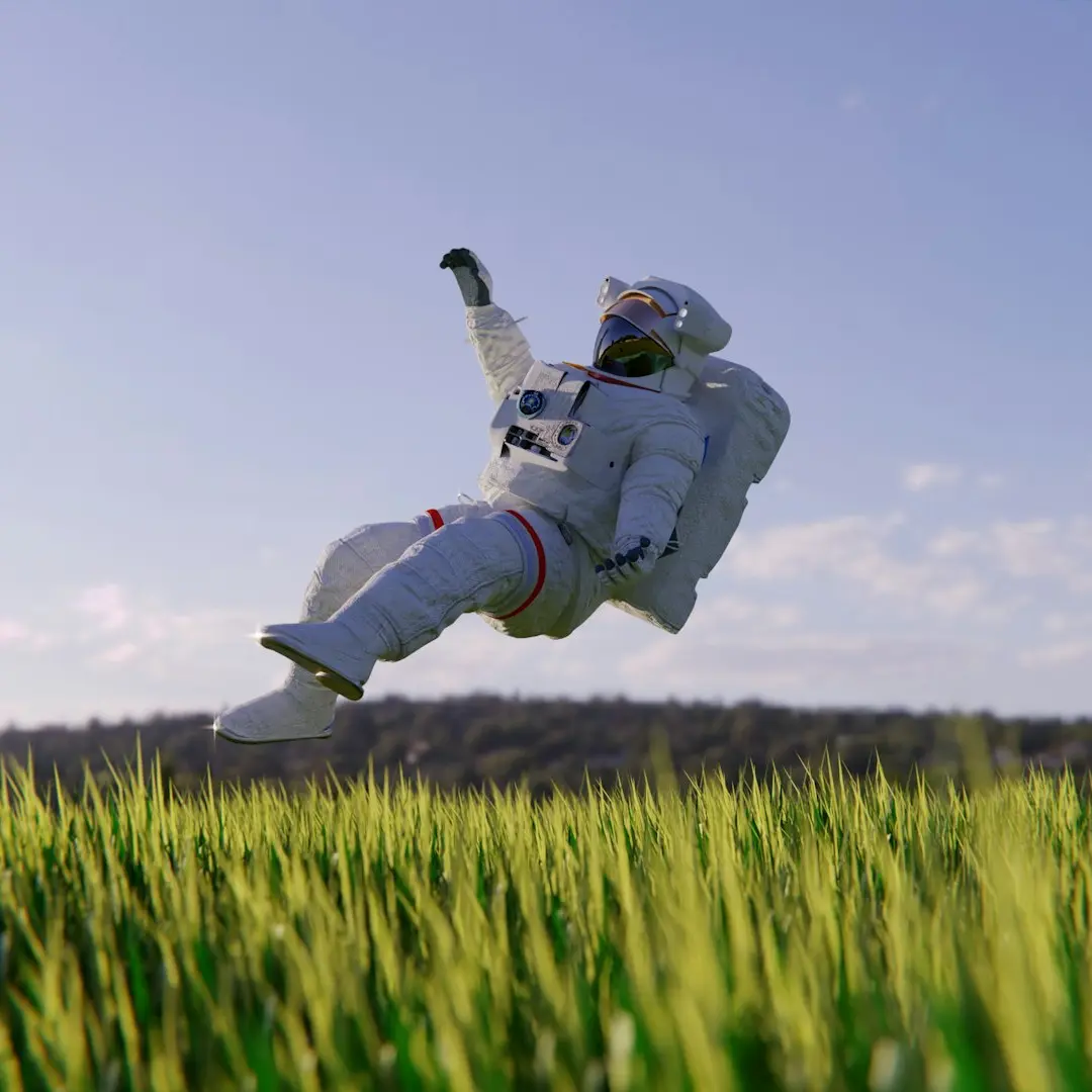a person in a white suit jumping in a field of grass